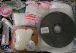 A mixed collection of items: chair covers, beauty products, fabric etc (1 tray).