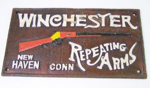 A reproduction cast metal Winchester rifle advertising sign: