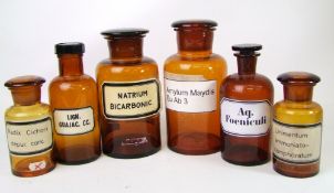Six vintage brown glass pharmacy jars with lids: