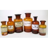 Six vintage brown glass pharmacy jars with lids: