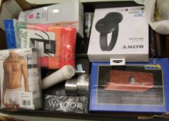 A mixed collection of items: Sony bluetooth headphones, sonic brush, torches, Calvin Klein underwear