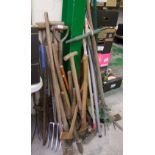 A large quantity of gardening hand tools: rakes, spades, axes etc.