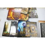 A collection of Lord of The Rings items to include: Monopoly set, magazines, Display Stand etc