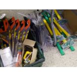 A mixed collection of tools: saws, pick axe heads, sledge hammers etc.