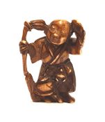 A carved ivory Meiji period netsuke: in the form of a Japanese elder, 4cm in height.
