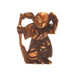 A carved ivory Meiji period netsuke: in the form of a Japanese elder, 4cm in height.