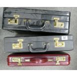 Three briefcases: Two in black and one in burgundy. (3)