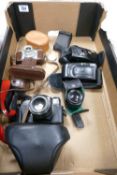 A mixed collection of 35mm camera equipment to include: Zenit TTL, Braun Paxette, Nikon AF200, Canon
