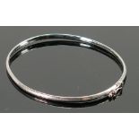 9ct hallmarked white gold ladies bangle: Weight 2.9g, internal measurements 58mm x 56mm appx.