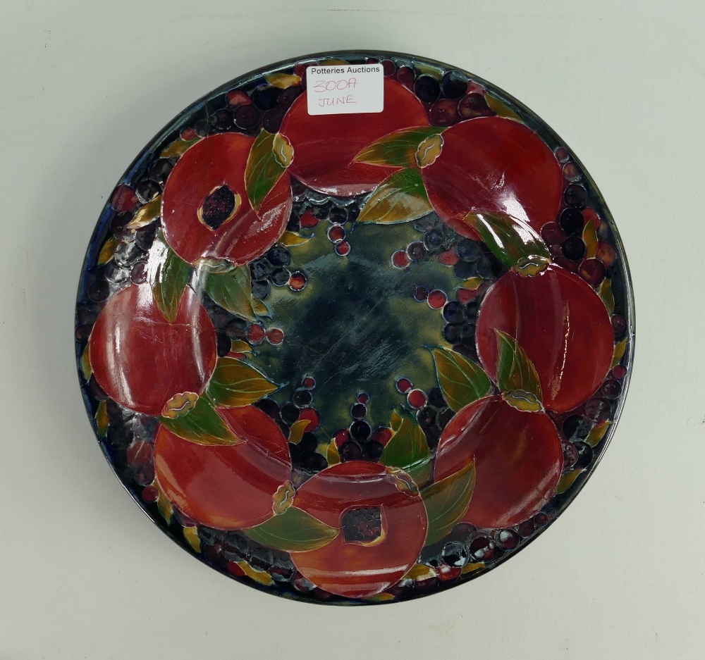 William Moorcroft Burslem large dish :decorated in the pomegranate design, d28cm. (broken into 4