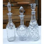 Three crystal decanters: two with ceramic labels