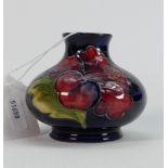 Moorcroft vase in the Hibiscus pattern: 7 cm high with impressed mark to base.