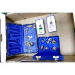 A mixed collection of items to include: cased nautical theme key rings, glass & chrome bottle