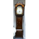 Oak Longcase clock with Mahogany crossbanding by Bramall Stockport: Painted arch dial, the case