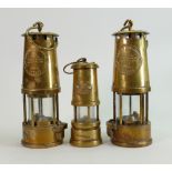 Two Eccles Type 6 brass Miners lamps : and a smaller Welsh novelty musical miners lamp. (3)