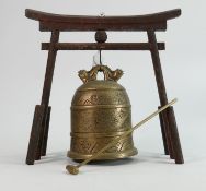 Oriental brass bell on wooden stand: Height of stand 26.5cm