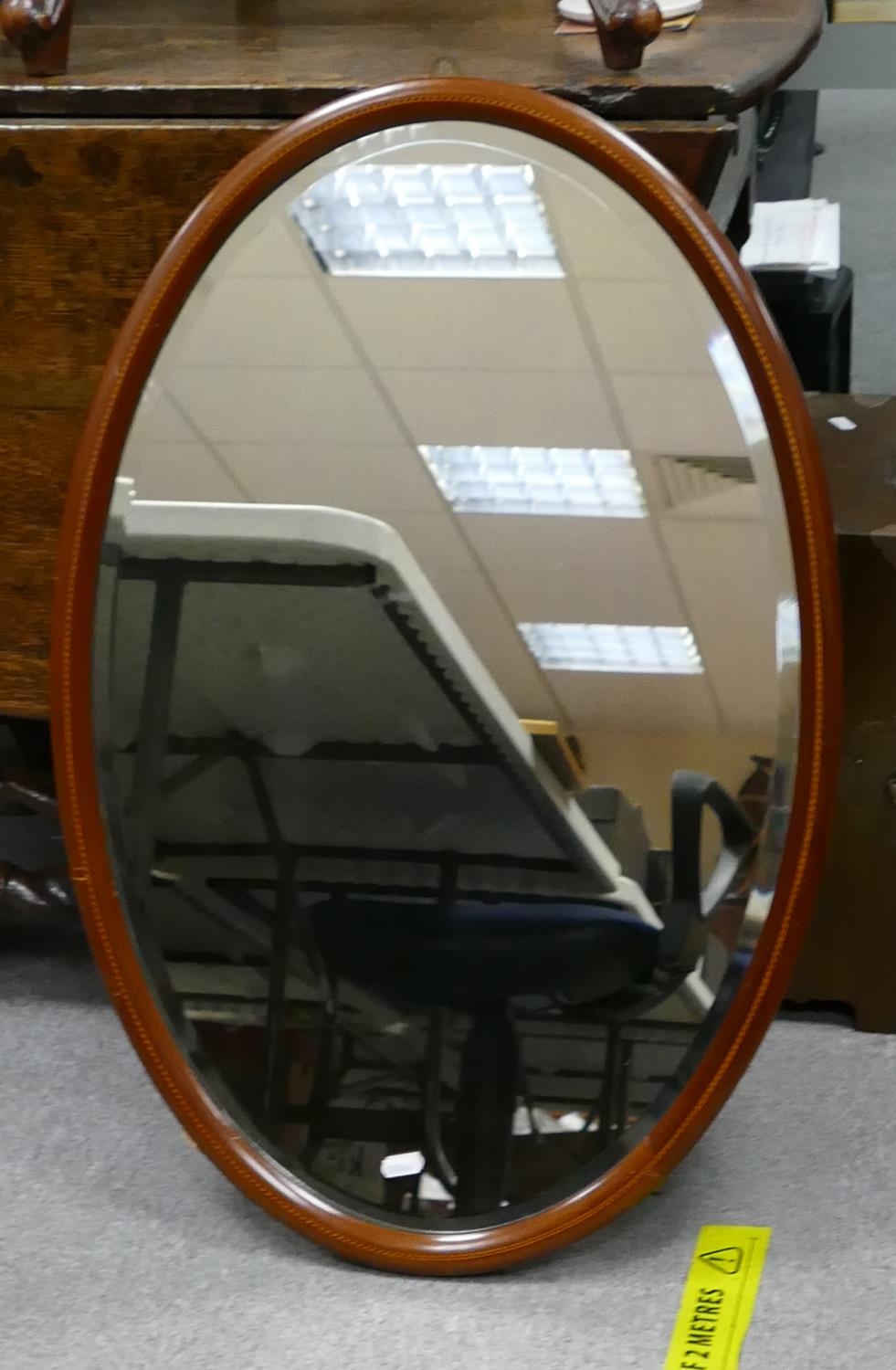 Large oval inlaid Edwardian wall mirror: Height at longest 77cm.