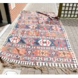 Large Kilim carpet: Measures 348cm x 188cm showing signs of some considerable wear.