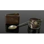 A collection of silver items: including small vesta case, spoon and serviette holder, 69.8g. (3)