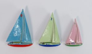 A set of 3 Wade porcelain Yacht figures: In green, blue and pink colours. (3)