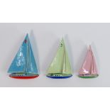 A set of 3 Wade porcelain Yacht figures: In green, blue and pink colours. (3)