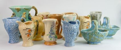 A collection of Wade Art Deco pottery: Including Budgerigar jug and several smaller jugs, baskets