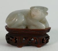 Early 20thC Chinese small Jade study of a Ram: On carved wood base, height 4.25cm x length 5.5cm.