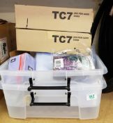 A mixed collection of items: plastic storage boxes, stationary items etc.