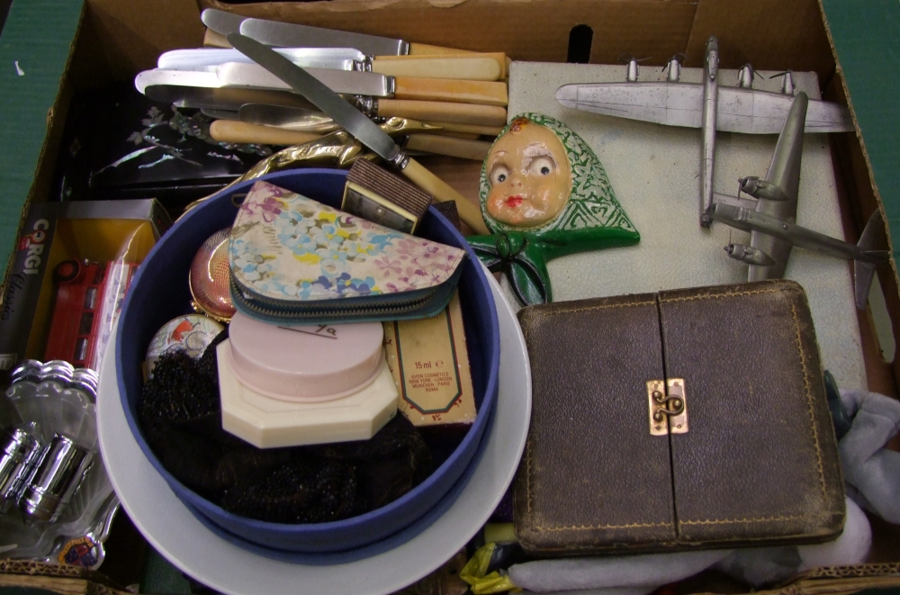A mixed collection of items: savings bank, damaged silver hand mirror, mounted car mascot, cased