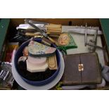 A mixed collection of items: savings bank, damaged silver hand mirror, mounted car mascot, cased