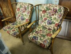 A pair of priory style mid century armchairs: on castors, sprung base (2).