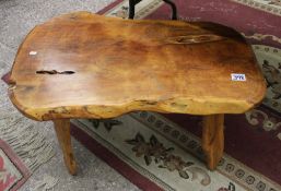 A teak 'tree slice' coffee table: approx 80cm in length.