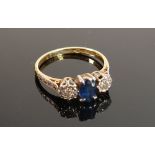 18ct gold & platinum ring: set with central sapphire (7 x 5mm) & diamonds either side (2.5mm),