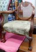 1920s carved walnut open armchair: with bergere panel and ball and claw feet.