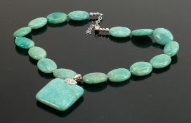 Polished turquoise coloured stone necklace: with silver clasp.