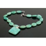 Polished turquoise coloured stone necklace: with silver clasp.