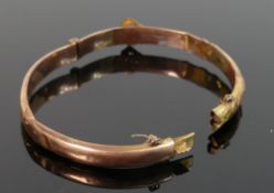 gold coloured metal bangle tested as 9ct or better: Item badly damaged, and weighing 6.5 g.