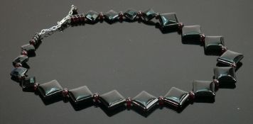 Costume polished brown stones necklace; with silver clasp.