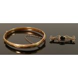 9ct gold brooch and gold cased metal core bangle: Brooch weighs 2.5g.