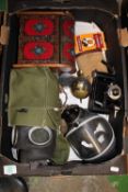 A mixed collection of items to include: cased decanter set, gas mask, Kodak bellowed camera,
