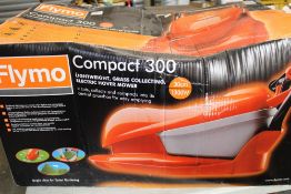 A boxed/unused Flymo Compact 300 lawnmower: box a/f.