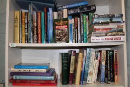 A large collection of books with a War/Military theme: 3 shelves.