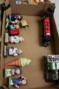A mixed collection of items to include: train theme money boxes, small condiment figures including