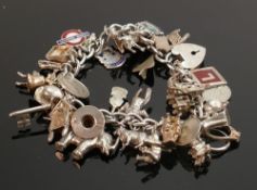 Silver charm bracelet with approx 35 charms, 96.6g: