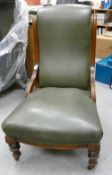 Edwardian Oak green leather Nursing Chair: Chew marks to front left leg.