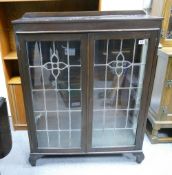 Darkwood display cabinet: With leaded glass doors.