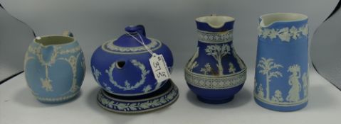 A collection of Dip Blue Wedgwood Jasper Ware to include: Jugs, Teapot, Teapot Stand & staple