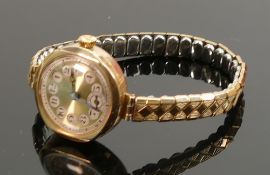 ladies vintage 9ct gold wristwatch: with gold plated expandable strap.
