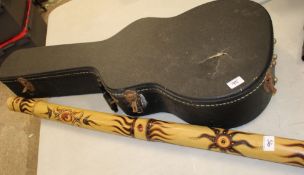 A Didgeridoo: together with a vintage hard guitar case (2).