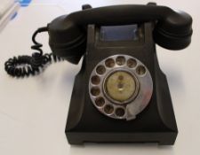A vintage black bakelite telephone: missing drawer and one foot